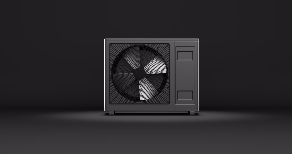 Compact dark grey air-to-water heat pump on a dark studio background