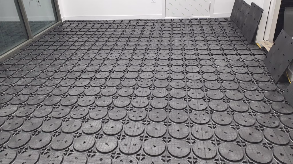 HOYA Ondol dry panels laid across a room before the pipe goes in